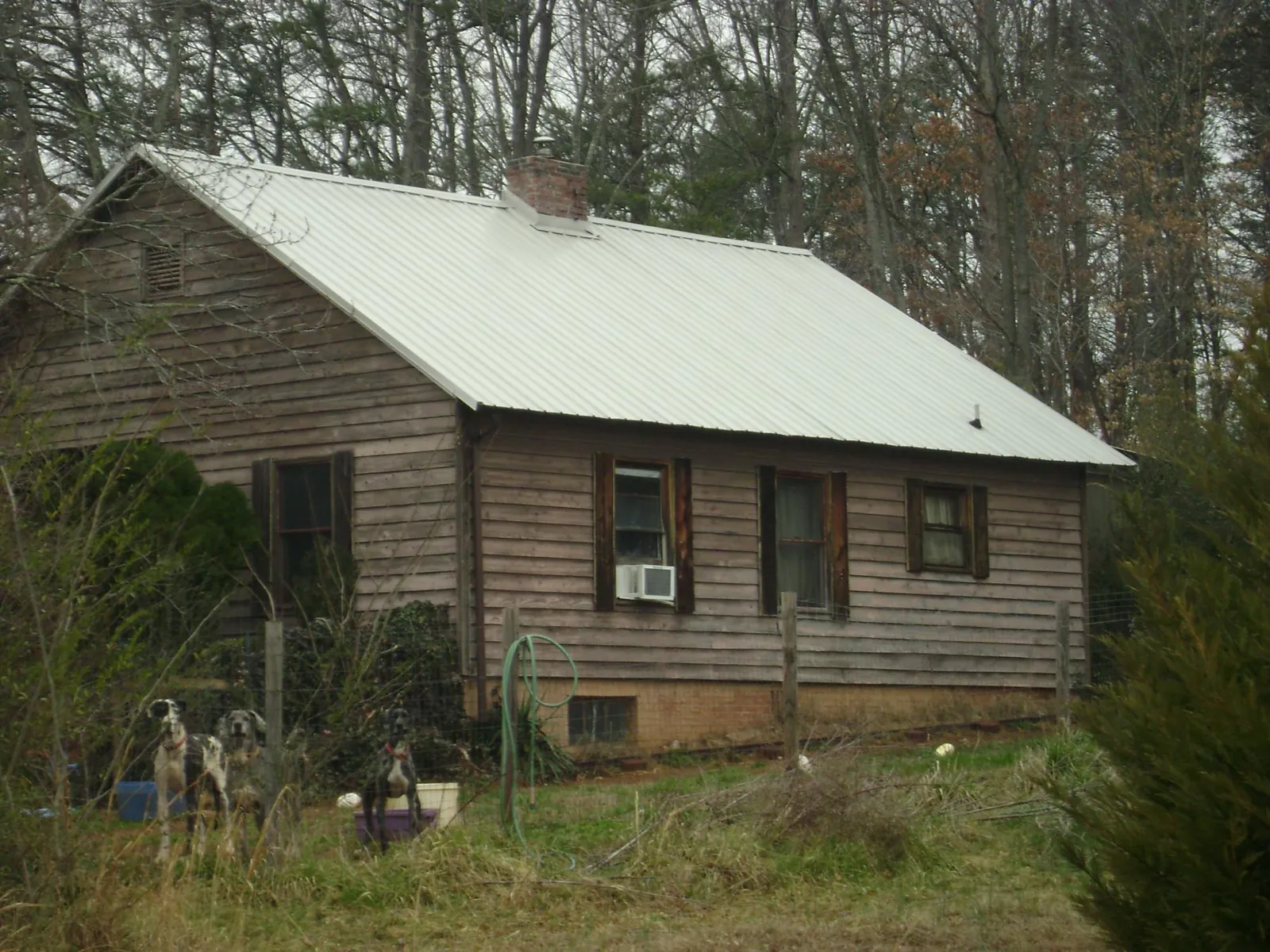 White metal roof on an old wood sided farmhouse, from a Metal Roof Installation job in Middlefield